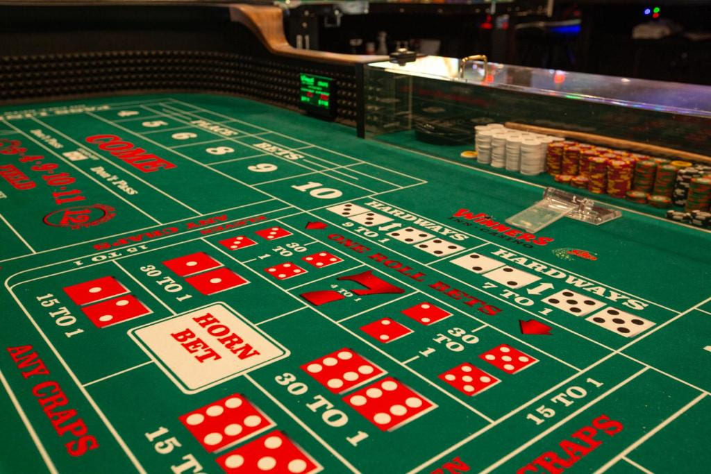 Craps table close-up with dice betting layout and chips
