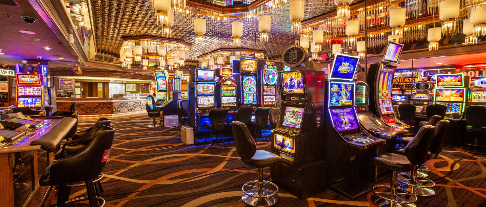 Casino floor with slot machines and bar seating