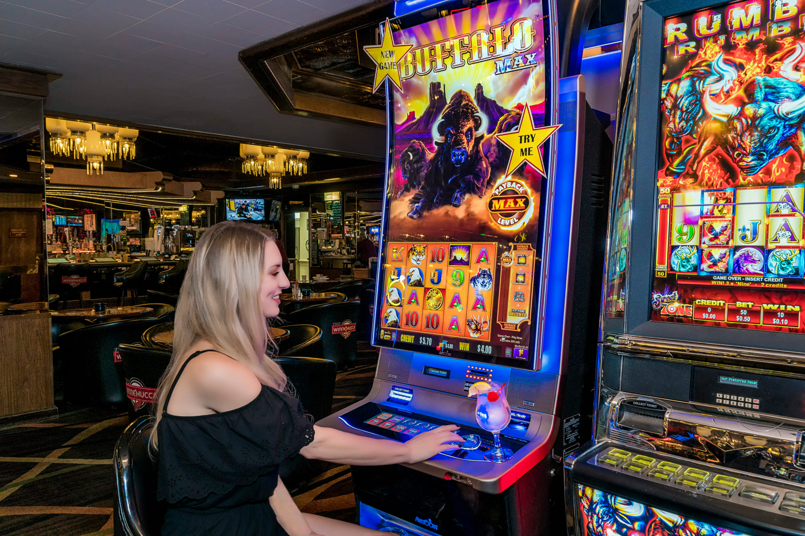 Guest enjoying a slot machine in the entertainment room