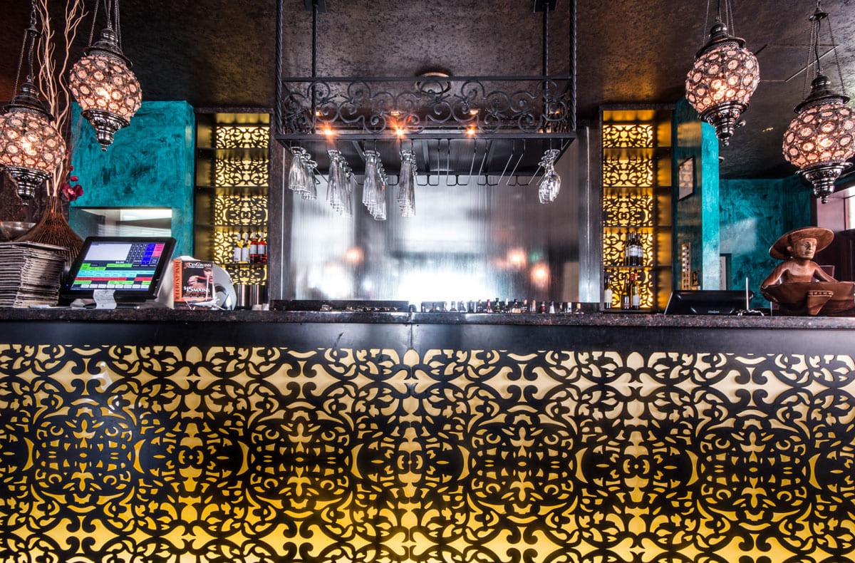 Ornate restaurant bar counter with hanging lanterns
