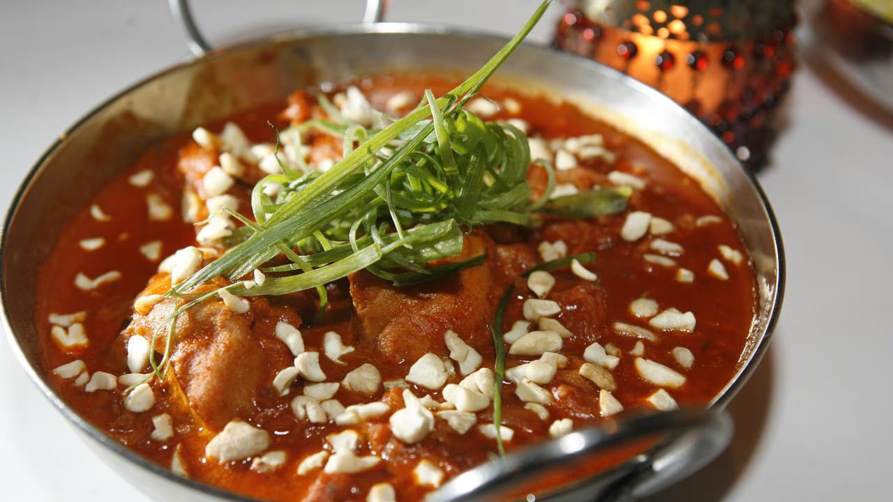 Close-up Indian curry with cashews and green onion