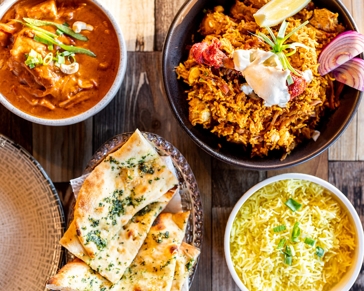 Indian food spread with biryani curry naan and rice