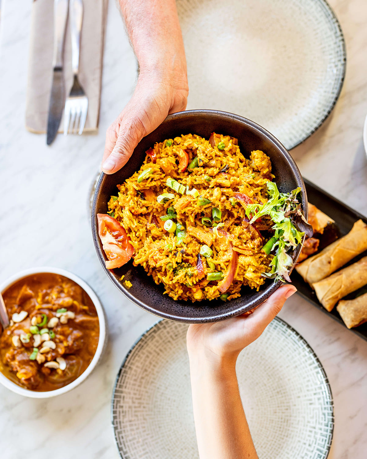 Rice bowl with curry and spring rolls